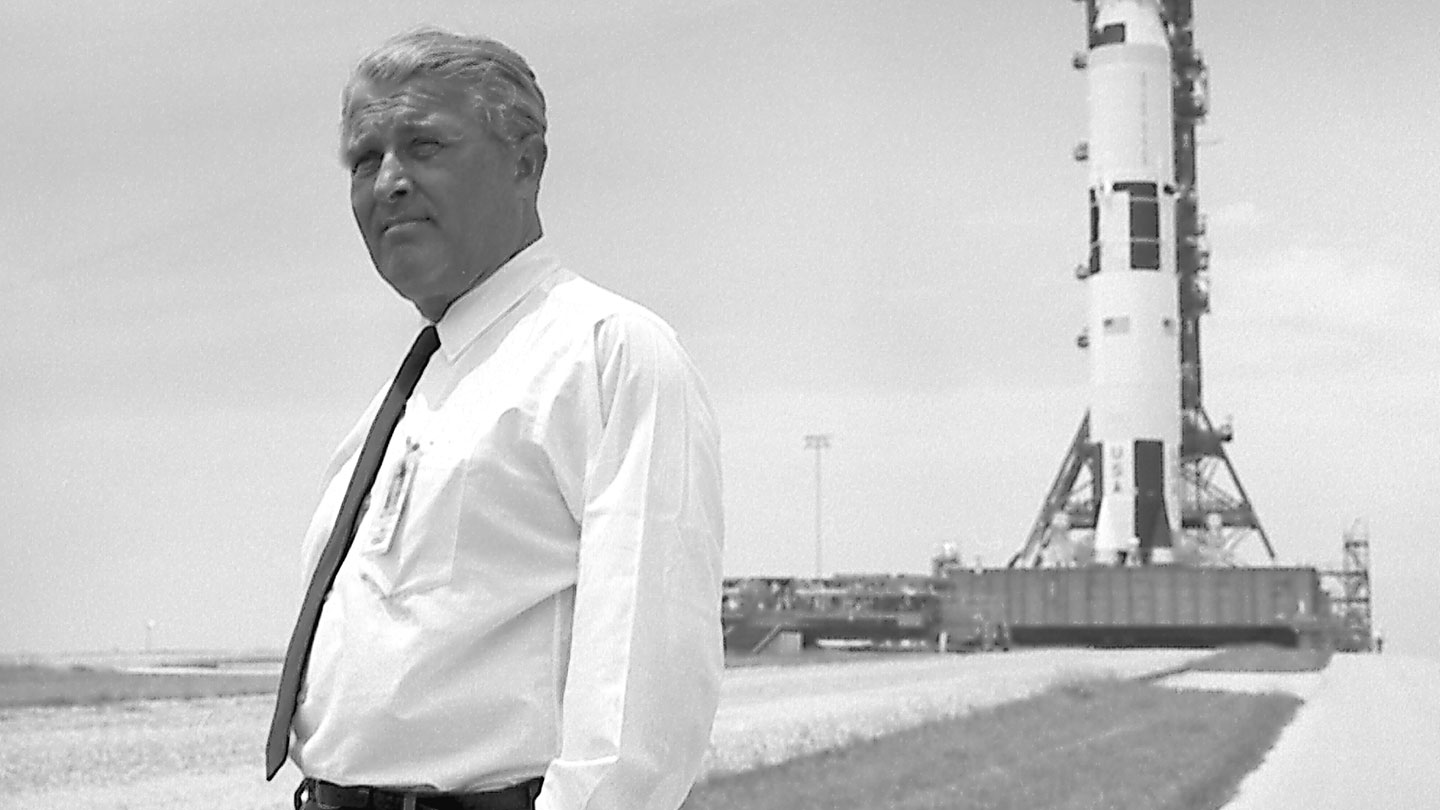 Wernher von Braun pauses in front of the Saturn V ?>