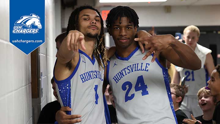 Two UAH Basketball players in uniform posing for camera.