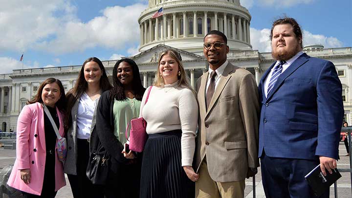 Students standing in front of capital hill in Washington D.C.