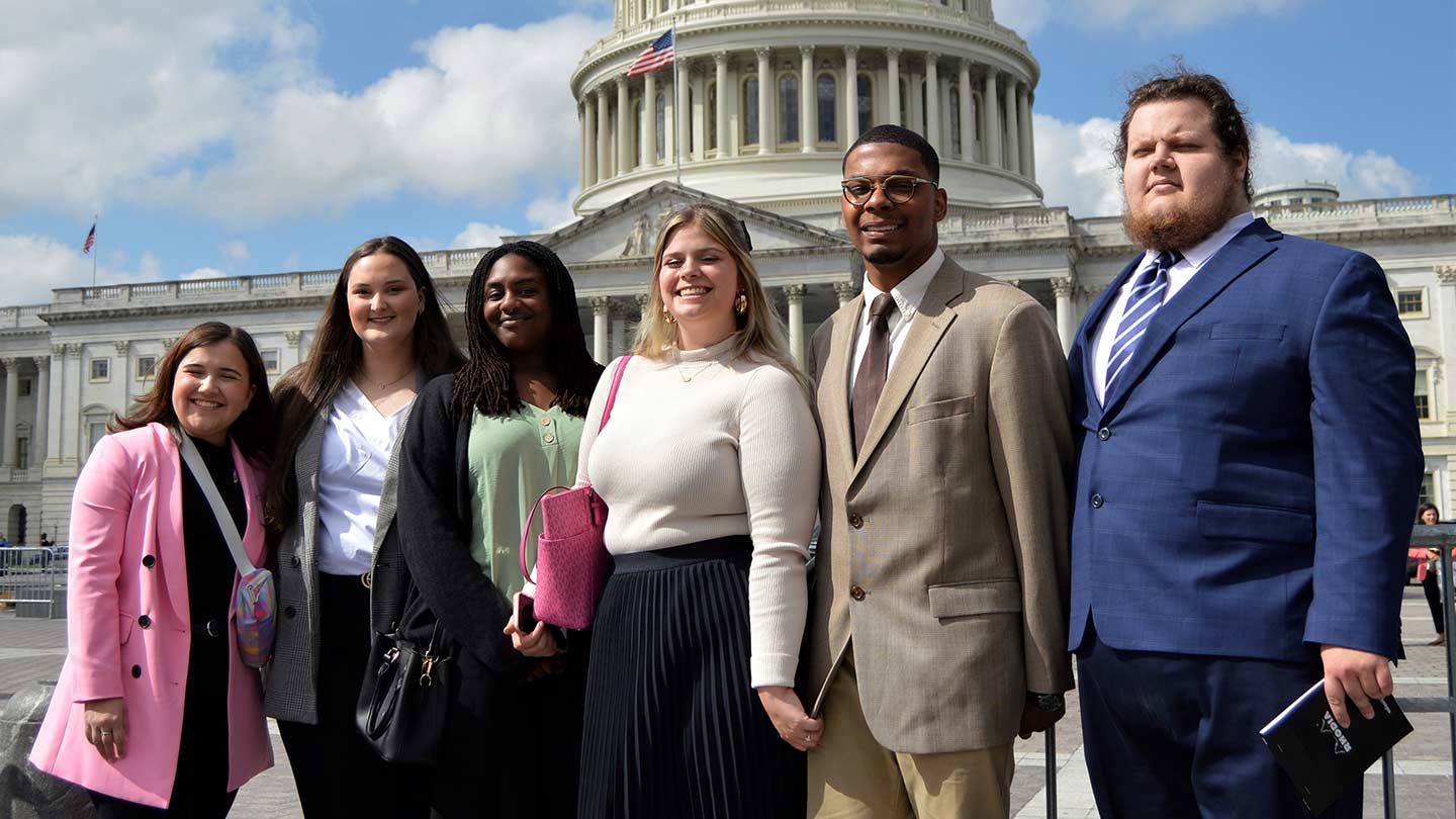 Kristian Erskine poses with his classmates in front of the United States Capitol building in Washington D.C.