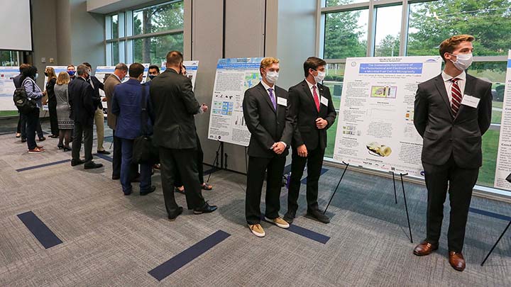 Photo of students presenting their posters at the 14th annual Wernher von Braun Memorial Symposium student poster competition.