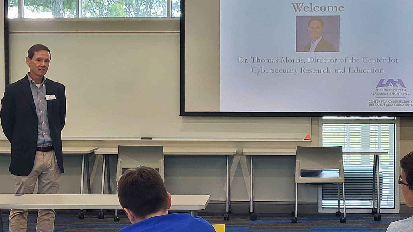 Tommy Morris giving a presentation in front of an audience.