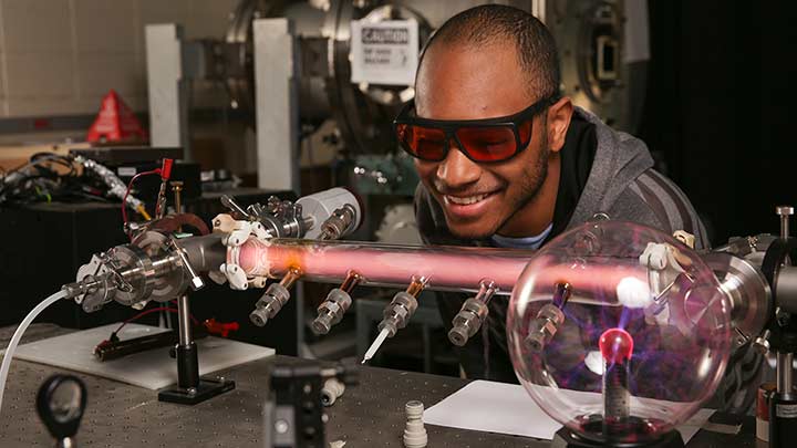 Zachary White working with plasma in a physics lab. ?>