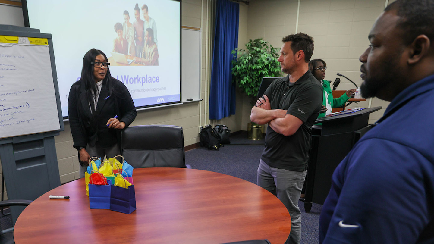 Jason Groncniak (center), building technician with Corporate Office Properties Trust (COPT), discusses leadership principles with fellow cohort members, Wendy Williamson-Jones, SHRM-CP (left) and Quanteaus Jones (right).