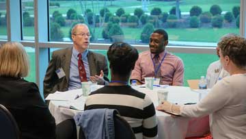 Professionals engaged in small group discussion.