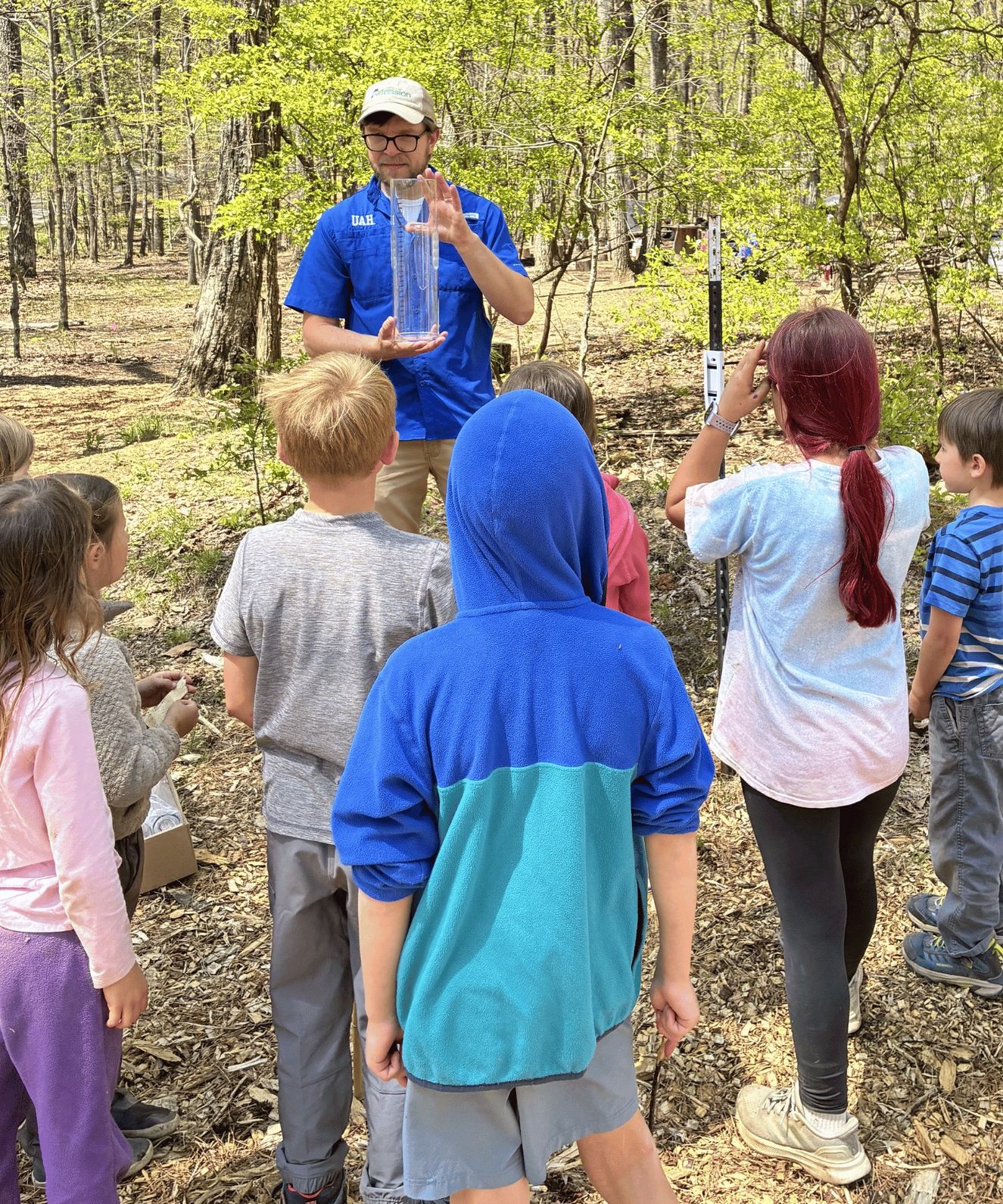 Alabama State Climatologist, Dr. Lee Ellenburg, teaching students how to properly measure rainfall totals from a CoCoRaHS rain gauge.