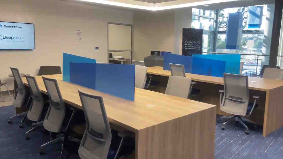 Several comfortable chairs at a long table with dividers