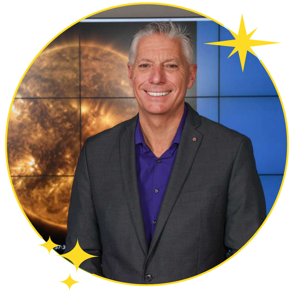 Circular framed headshot of Gary Zank. The background shows a close-up image of the sun and a blue paneled wall.