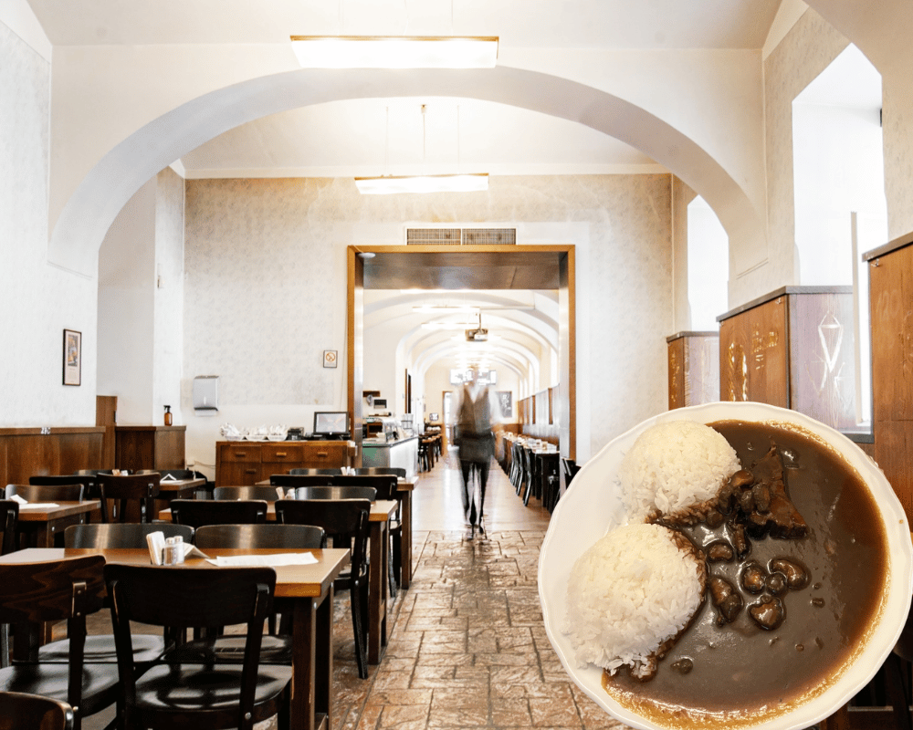 Long vaulted dining hall at Lokál Dlouhááá with wooden tables, alongside a plate of braised beef with pickles and rice.