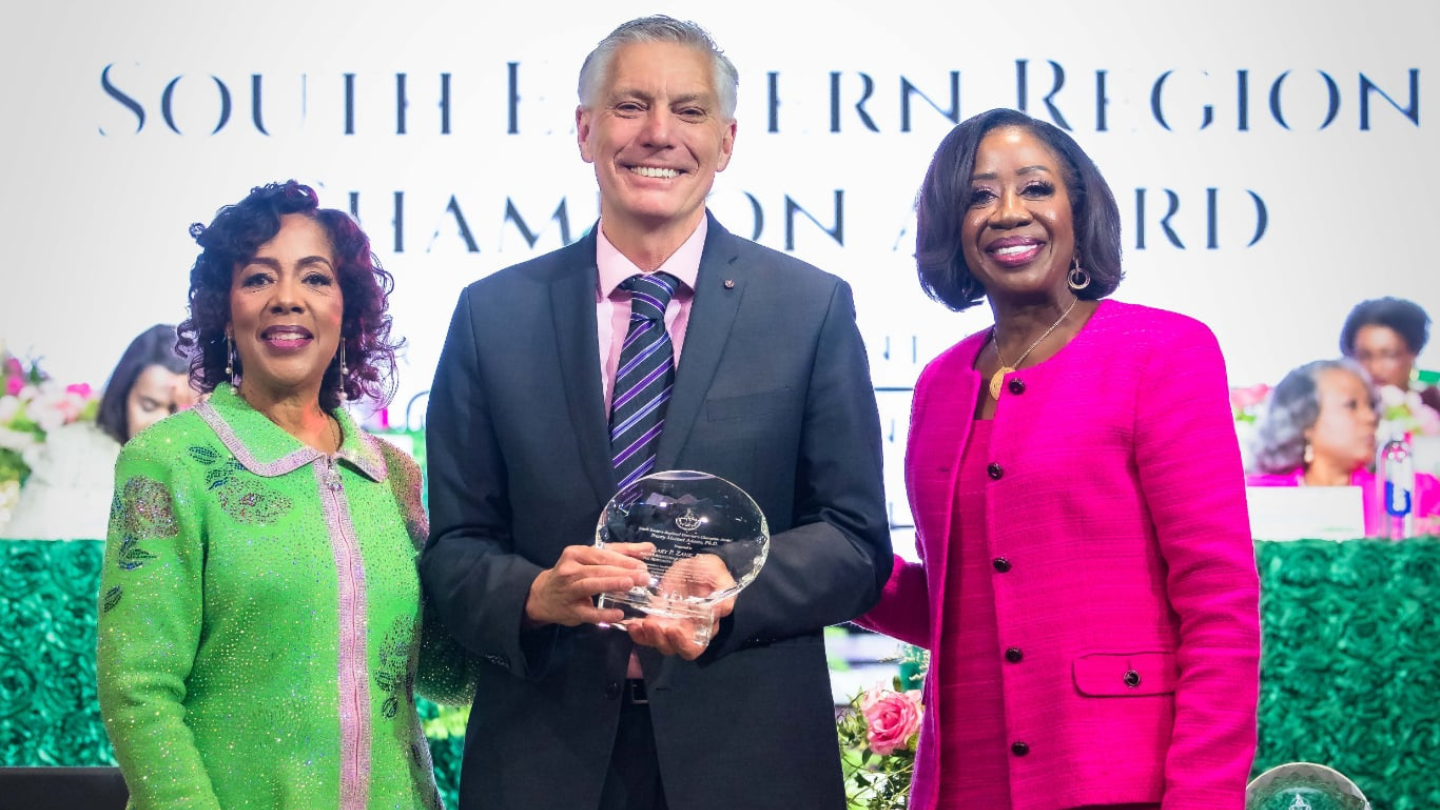 Dr. Gary P. Zank receiving the award from AKA CEO, Reed and SER Director, Adams.