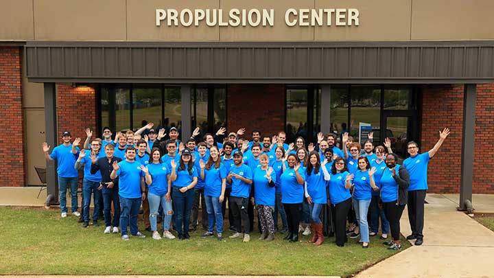 photo of spring 2023 prc graduates standing in front of the propulsion center building