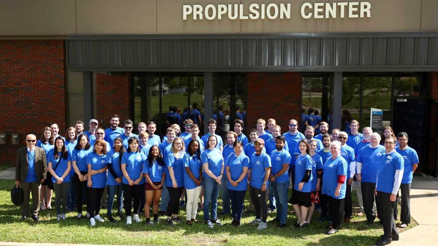 Spring 2019 Graduation Students standing outside, in front of the PRC Building