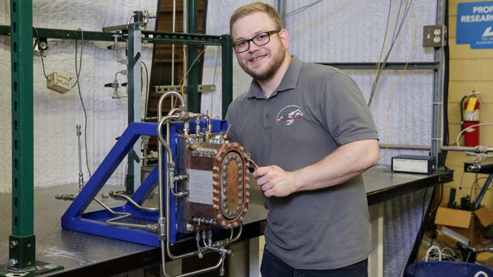 Evan Unruh stnading near a Rotating Deotonation Engine.